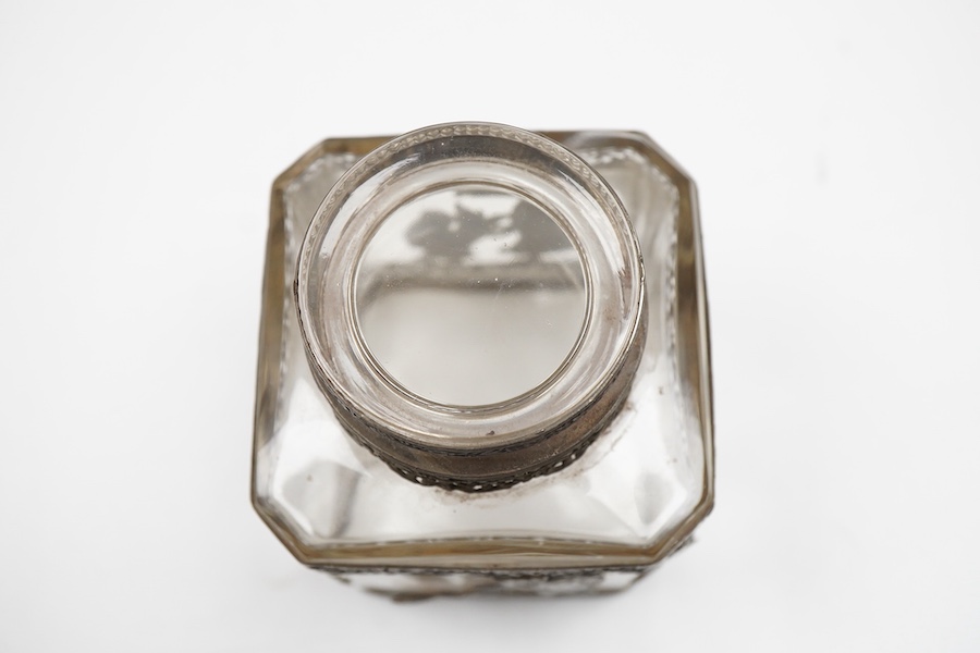 A late 19th/early 20th century French 800 standard pierced white metal mounted glass jar or tea caddy and stopper, decorated with classical scene of a lady with child, height 13.2cm.